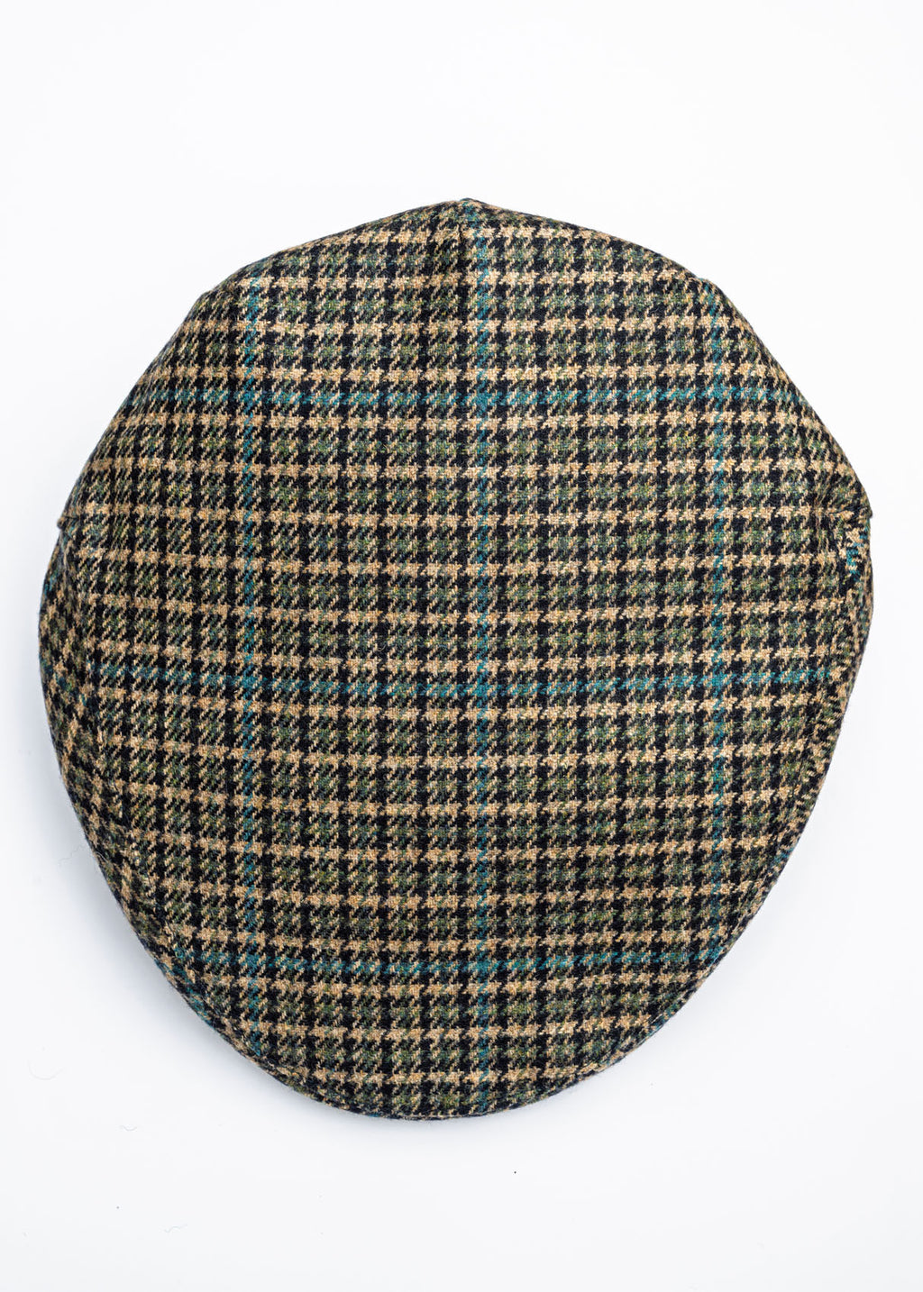 Houndstooth patterned flat cap on a beige background