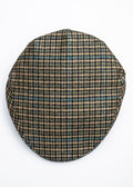 Houndstooth patterned flat cap on a beige background
