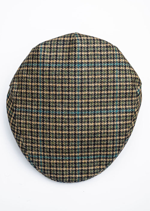 Houndstooth patterned flat cap on a beige background