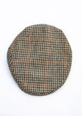 Houndstooth patterned flat cap on a white background