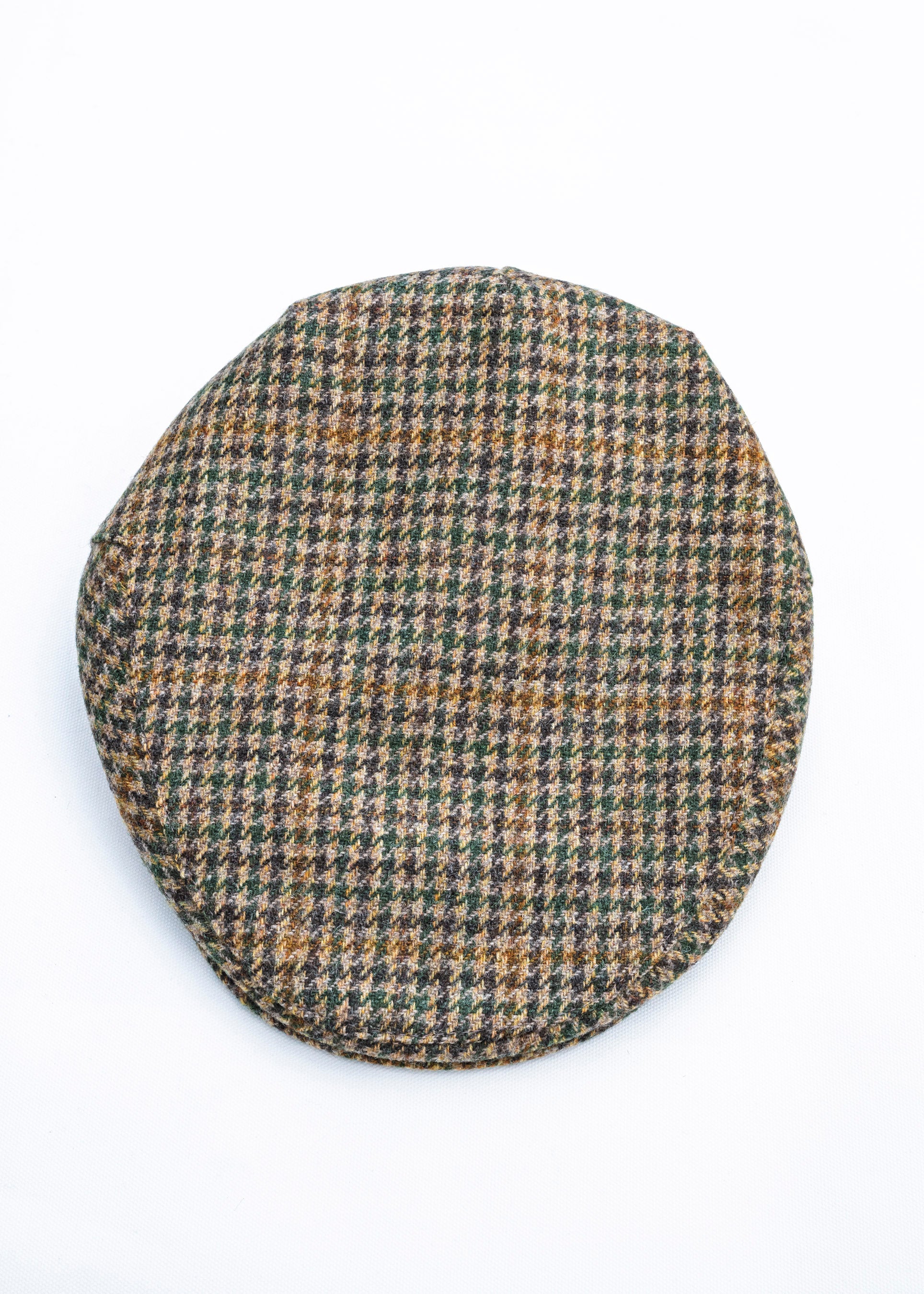Houndstooth patterned flat cap on a white background