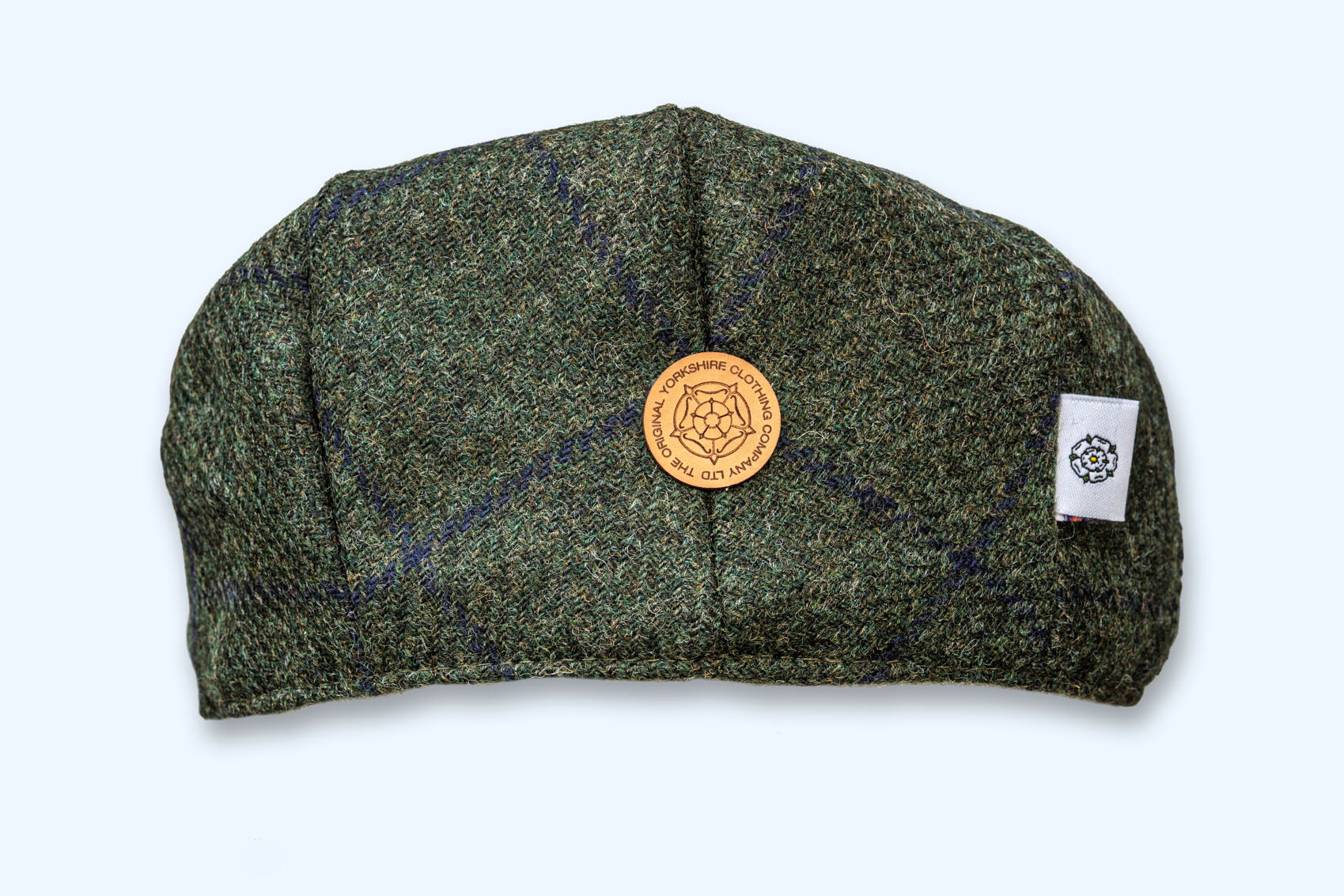 Green textured cap with a logo and brand tag on a white background