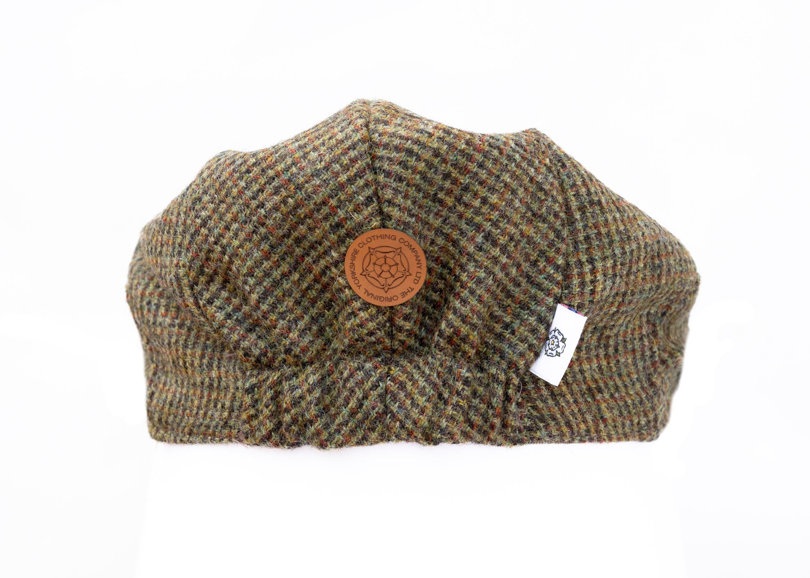 Tweed cap with a brand tag on a white background