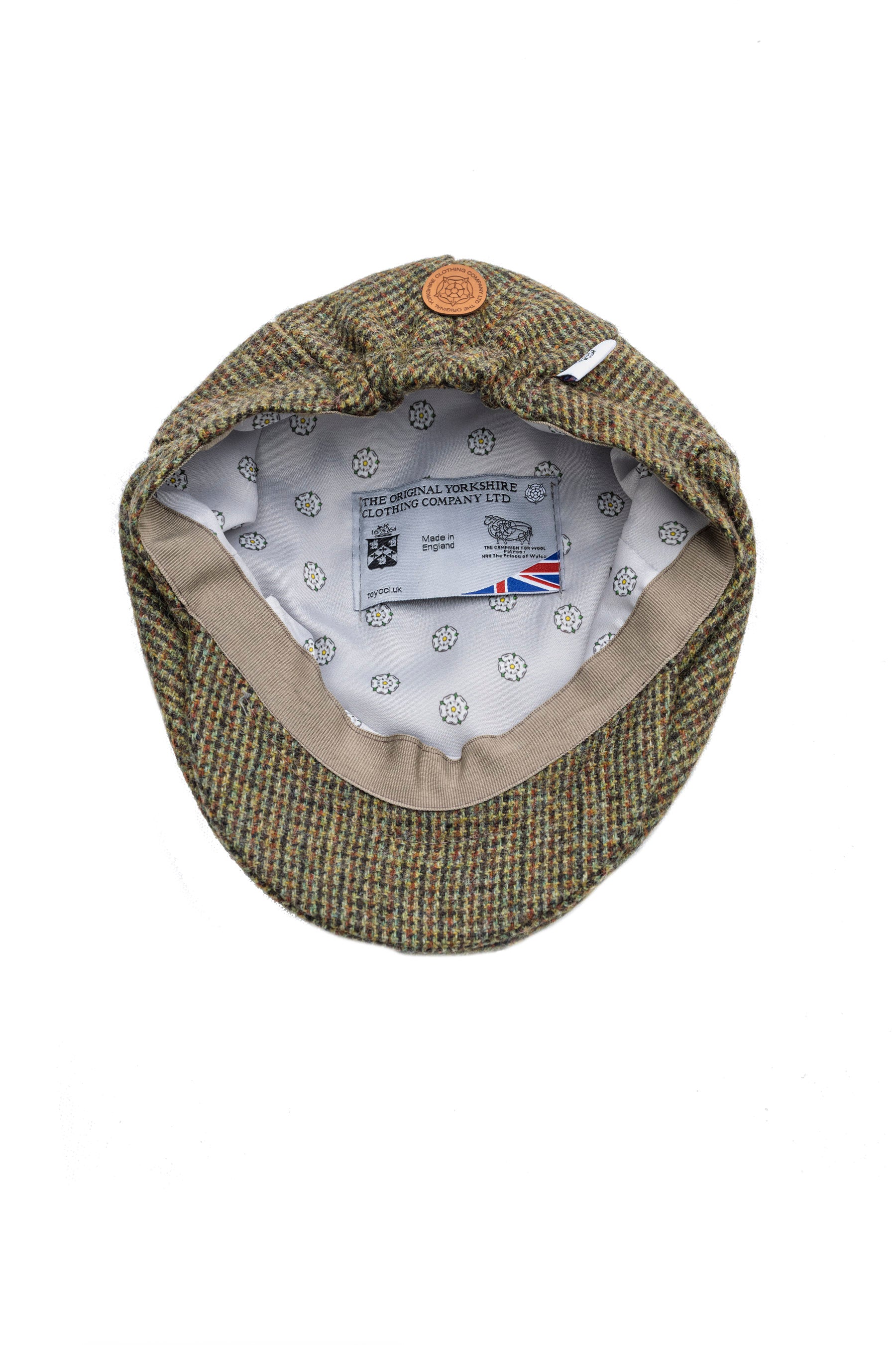 Green checkered flat cap with brand label on a white background
