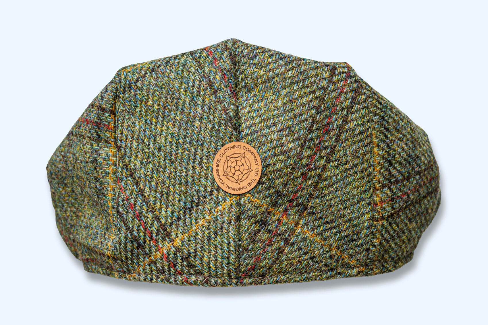 Green tweed cap with a logo on a white background