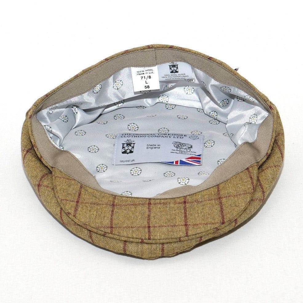 Brown checkered flat cap with brand label on a white background